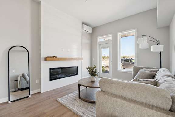 A modern living room with a fireplace and a couch.