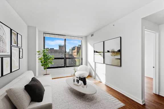 a living room with a couch and a large window at Chateau on Wells, Chicago