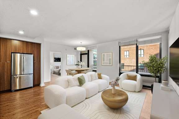A modern living room with a white sofa set and a wooden coffee table at Chateau on Wells, Illinois