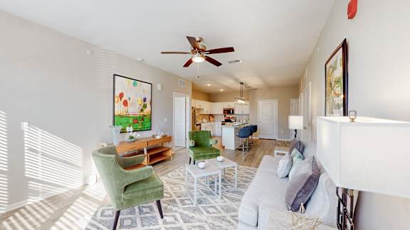A living room with a green chair and a white couch at The Slate, Jeffersonville, 47130