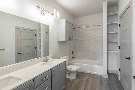 A white bathroom with a toilet, sink, and bathtub.