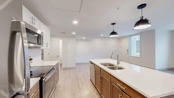 A modern kitchen with stainless steel appliances and wooden cabinets.