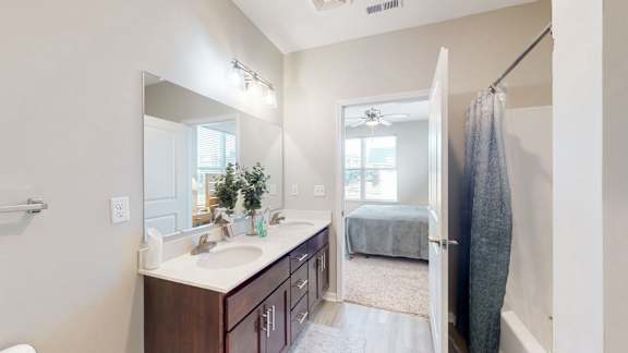 A bathroom with a white sink and a mirror at The Slate, Jeffersonville, 47130