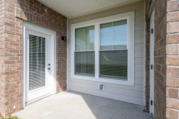 A white door and window on a house at Arbour Place Apartments, Jeffersonville, IN