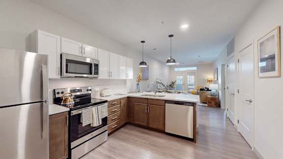 A modern kitchen with stainless steel appliances and wooden cabinets.