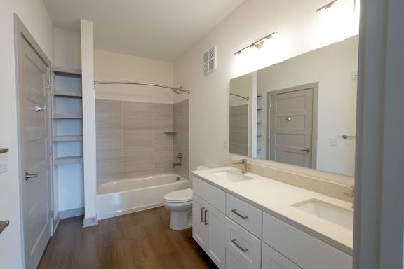 A bathroom with a white toilet, sink, and bathtub.