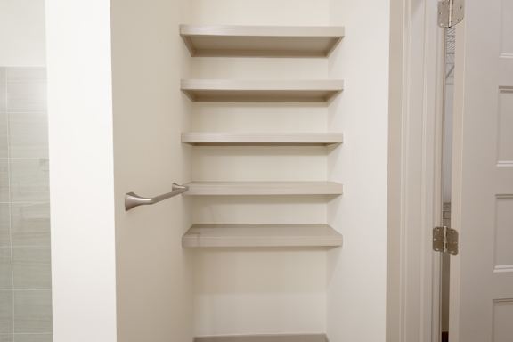 A set of white stairs with a handrail on the left side.