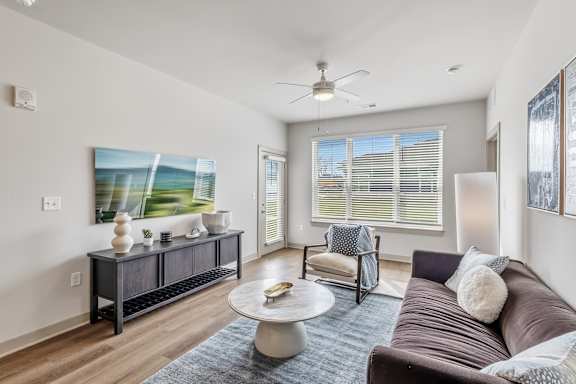 A living room with a brown couch and a coffee table.