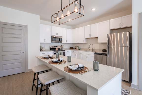 A modern kitchen with a white countertop and stainless steel appliances at Sage Springs, Elizabethtown, KY