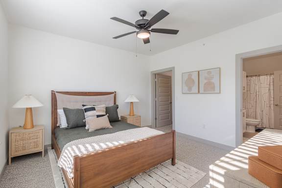 A bedroom with a bed, two lamps, and a ceiling fan at Sage Springs, Elizabethtown, KY