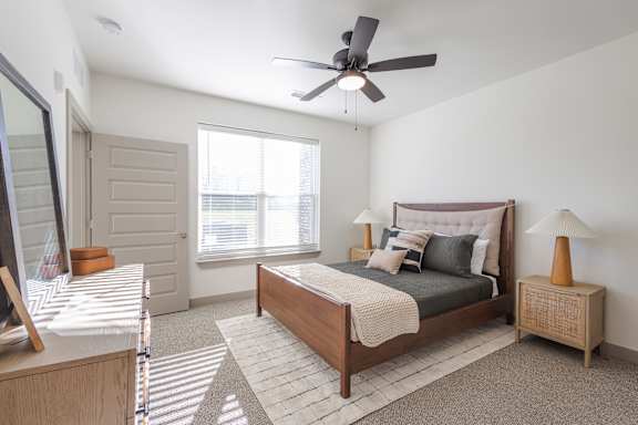 A bedroom with a bed, nightstand, and a ceiling fan at Sage Springs, Elizabethtown, KY