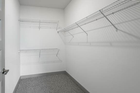 A white walk in closet with shelves and a door at Sage Springs, Elizabethtown, KY