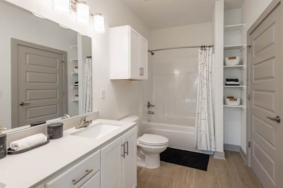 A white bathroom with a toilet, sink, and shower at Sage Springs, Elizabethtown, KY