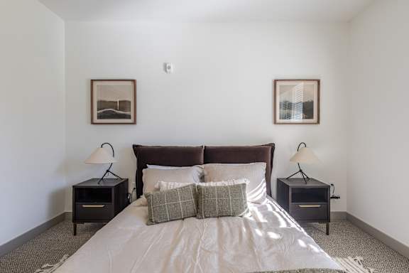 A bedroom with a large bed and two nightstands with lamps at Sage Springs, Elizabethtown, KY