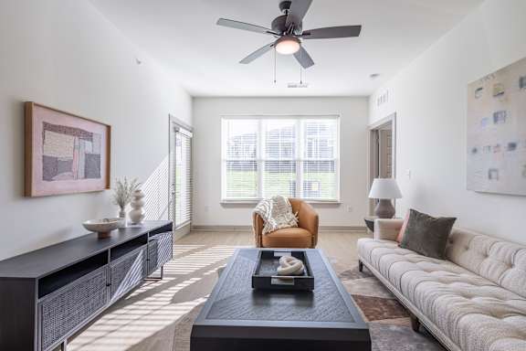 A living room with a couch, a coffee table, and a ceiling fan at Sage Springs, Elizabethtown, KY