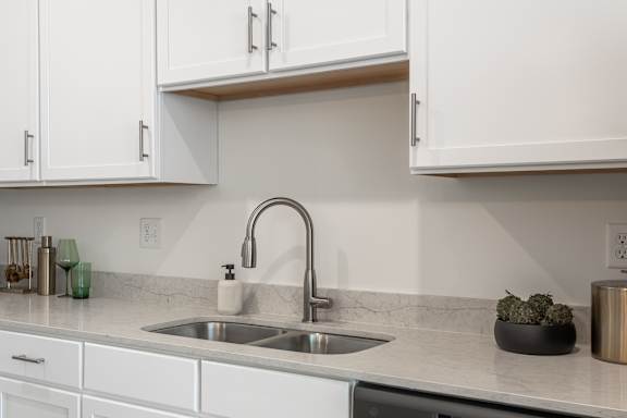 A kitchen with a sink and a bowl of green vegetables at Sage Springs, Elizabethtown, KY