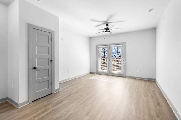 A room with a ceiling fan and a sliding glass door. at Arbour Place Apartments, Indiana