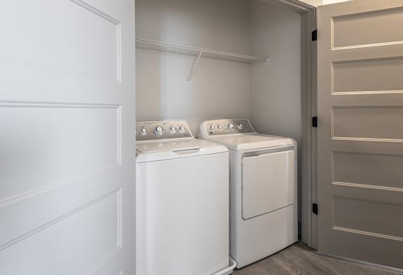 Two white washing machines in a laundry room. at Arbour Place Apartments, Indiana, 47130
