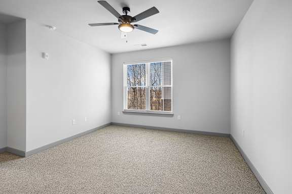 A room with a ceiling fan and a window with blinds at Arbour Place Apartments, Jeffersonville, IN