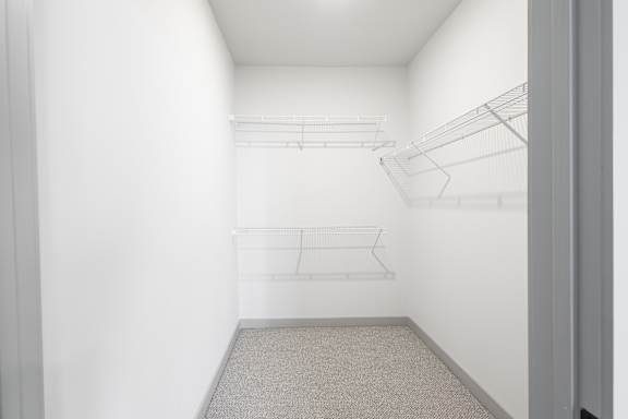 Empty room with shelves and carpeted floor. at Arbour Place Apartments, Jeffersonville, IN