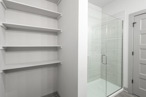A white shelving unit with a glass door at Arbour Place Apartments, Jeffersonville