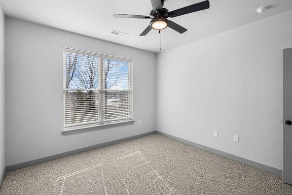 A room with a ceiling fan and a window with blinds at Arbour Place Apartments, Jeffersonville, IN, 47130