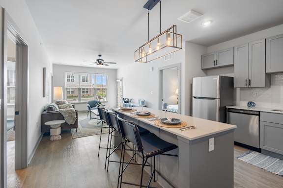 A kitchen with a table and chairs in the middle of the room.