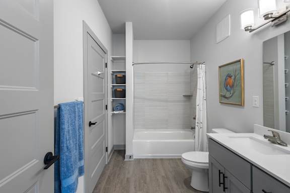 A bathroom with a white toilet, a white sink, and a white bathtub.