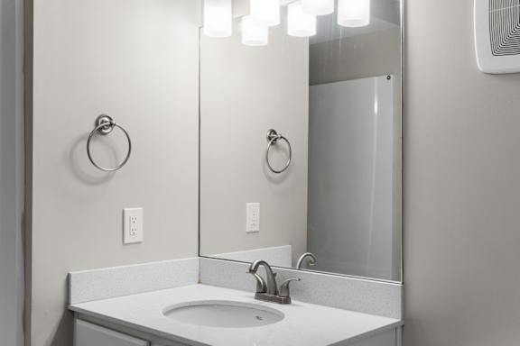 A bathroom sink with a mirror above it.
