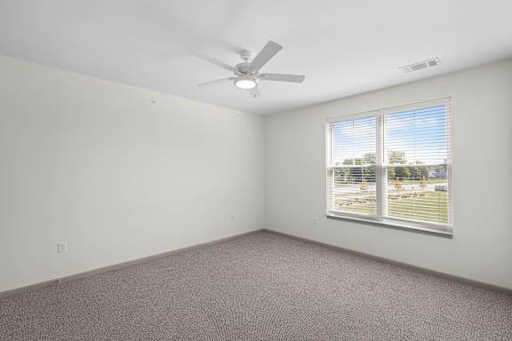 A room with a ceiling fan and a window with blinds.at Arlington Farms, Greenwood, IN, 46143