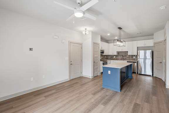 A kitchen with a blue island in the middle of the room.