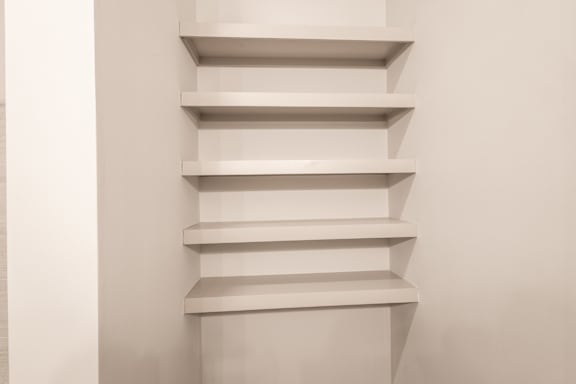A set of white shelves on a wall.
