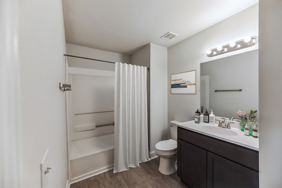 a bathroom with a shower and a sink and a toilet