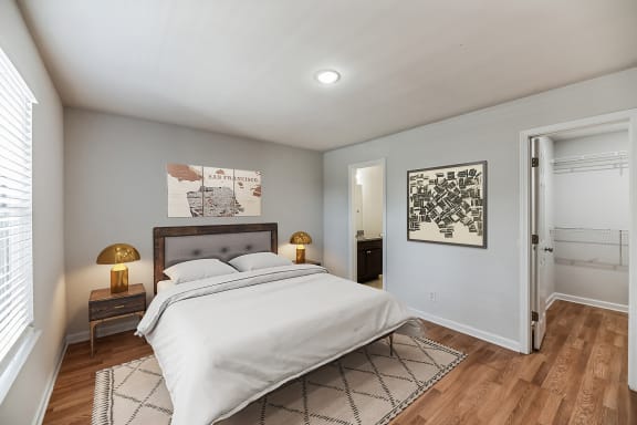 a bedroom with a bed and a door to a bathroom