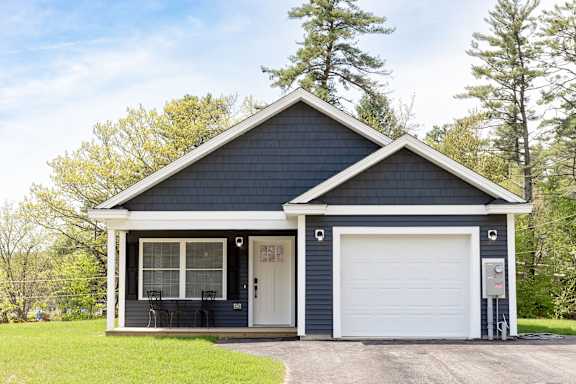 A two-car garage with a white door and a small porch.