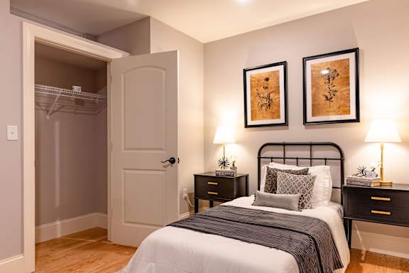 Floor Plan  A bedroom with a bed, nightstands, and two wall-mounted lamps.