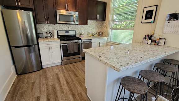a kitchen with stainless steel appliances and a granite counter top
