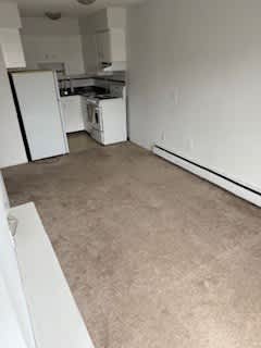 A small, empty room with a washer and dryer.