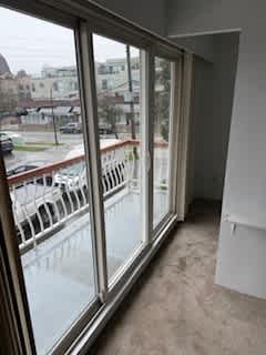 A view of a balcony from a window.