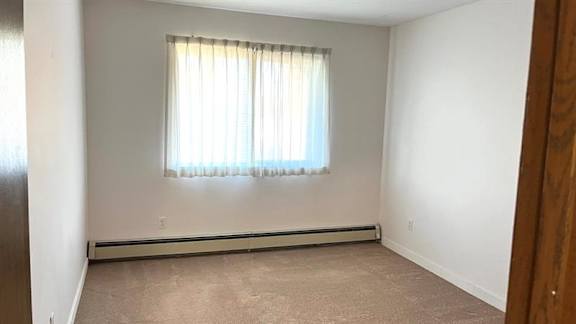 A room with a window covered by a white curtain.