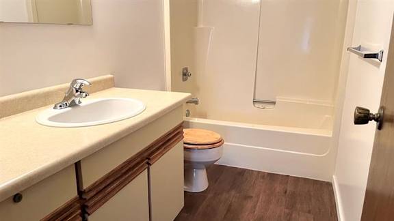 A bathroom with a sink, toilet, and bathtub.