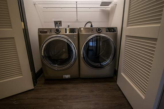 Two front loading washing machines in a laundry room.