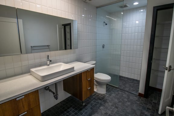 a bathroom with a toilet and a sink and a mirror