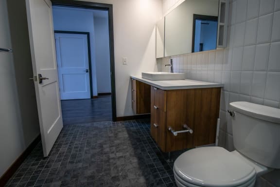 a bathroom with a toilet sink and a mirror