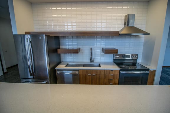 an empty kitchen with a stove and a refrigerator