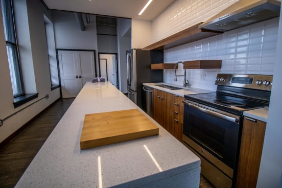 a kitchen with a cutting board on the counter