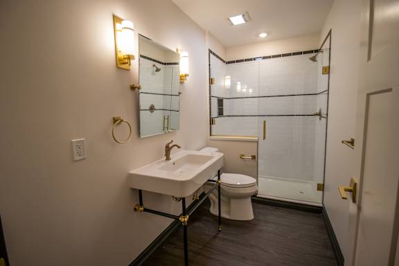 A bathroom with a sink, toilet, and shower.