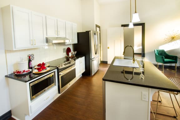 a kitchen with stainless steel appliances and black counter tops