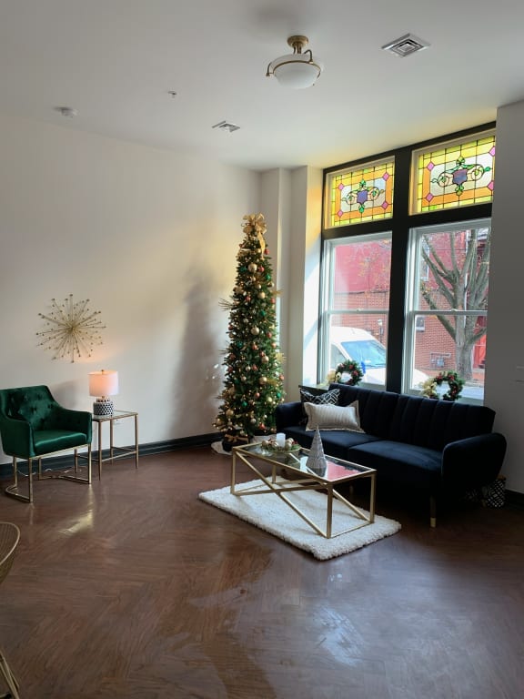 a living room with a christmas tree and a couch