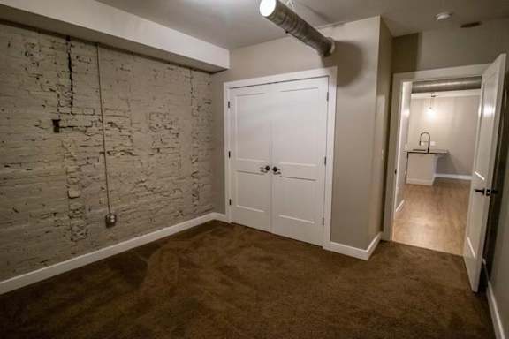 an empty room with a white door and a closet
